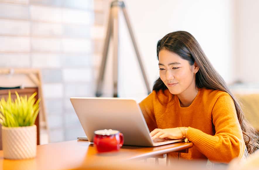 Woman sitting at desk with laptop