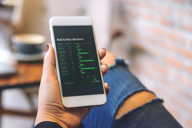 lady-looking-at-her-phone-to-check-bull-and-bear-market-bar-graph