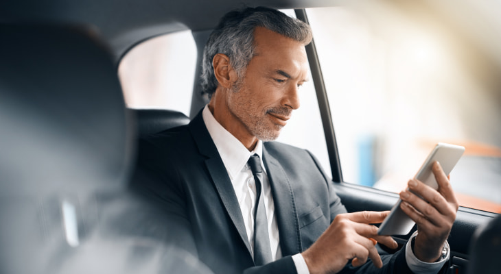 Man in a suit in car on phone