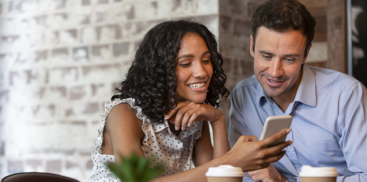 Two friends looking at phone