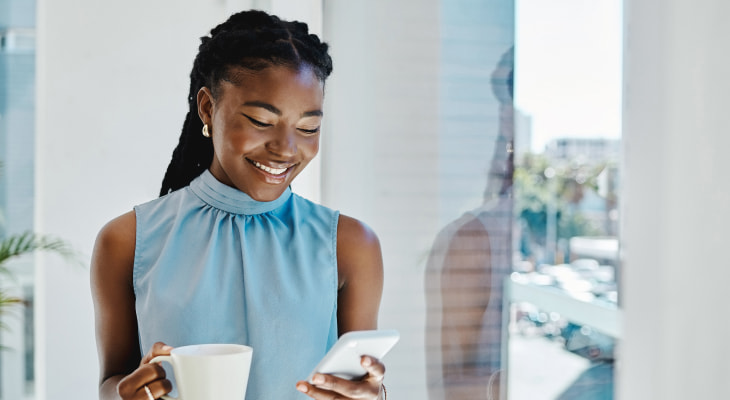 Young woman smiling at phone