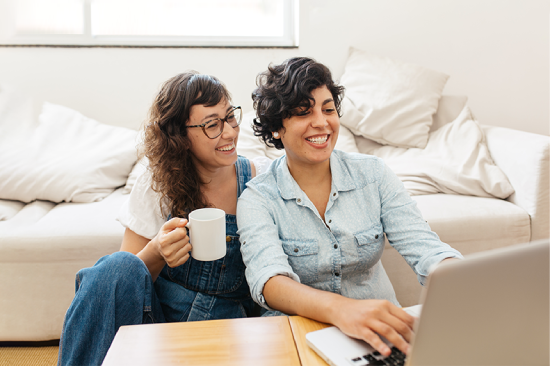 two-girls-looking-at-computer-smiling