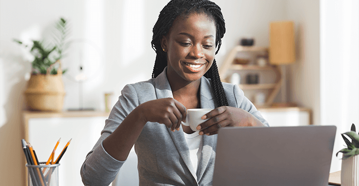 Woman smiling in front of laptop