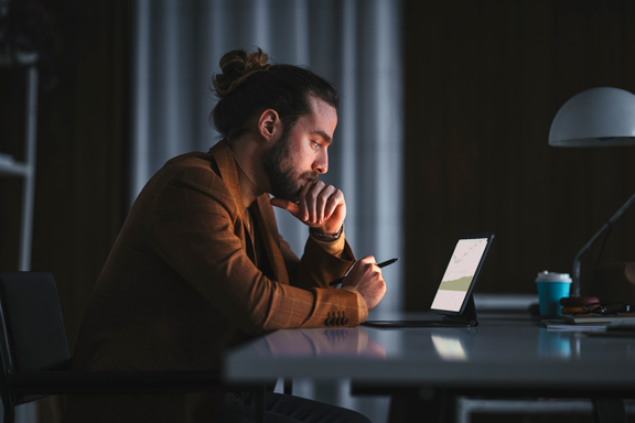 Man using laptop to check on his margin account buying power