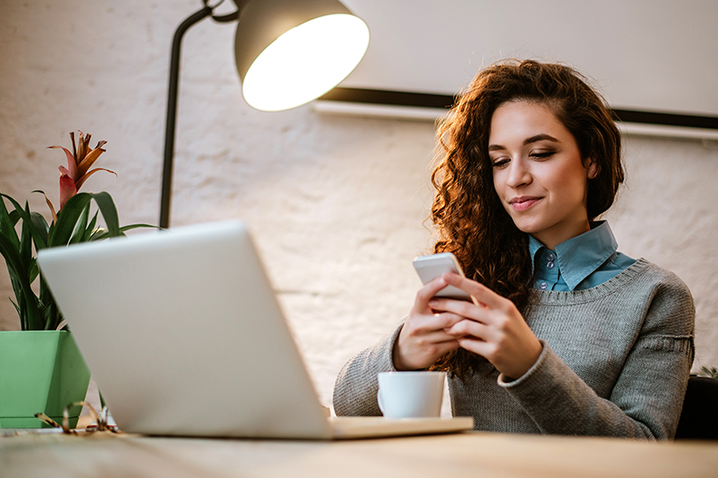woman looking at phone smiling