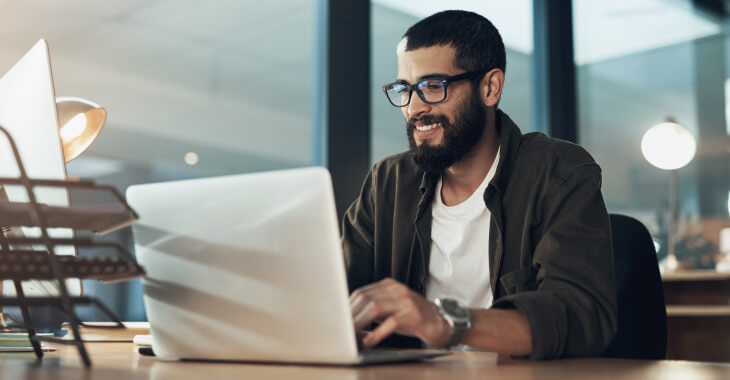 Man looking at laptop researching