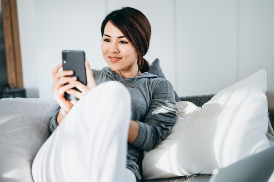 Woman looking at phone smiling