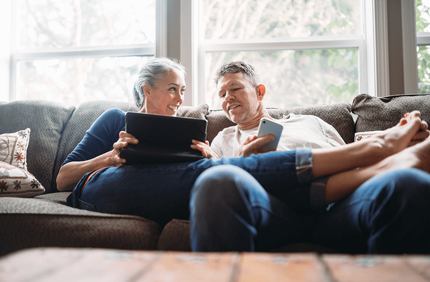 mature couple relaxing with tablet looking at RRSP