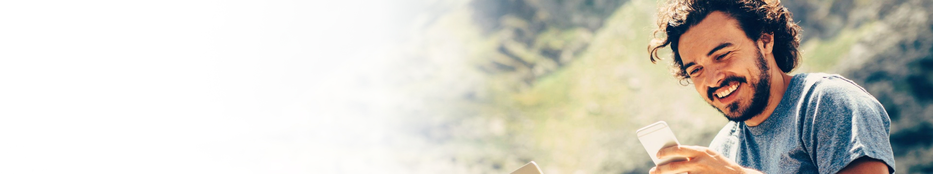 Men smiling looking at mobile