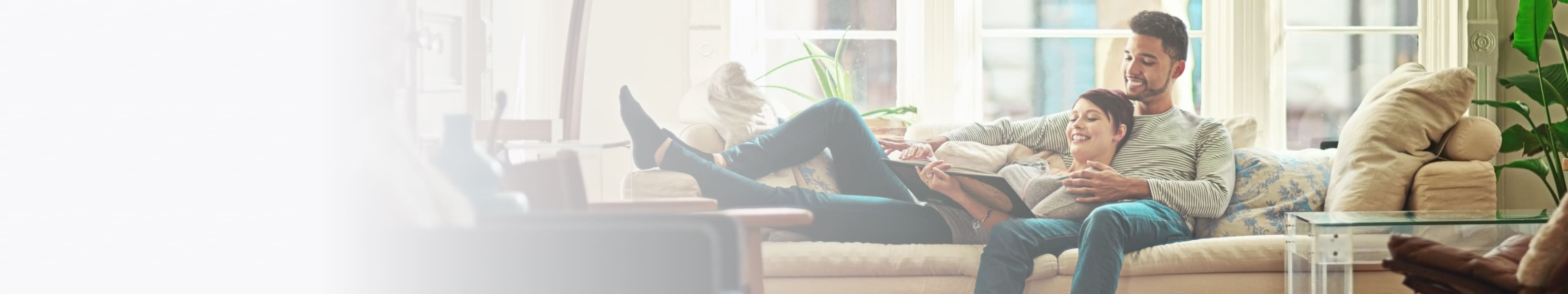 Couple on a couch looking happy