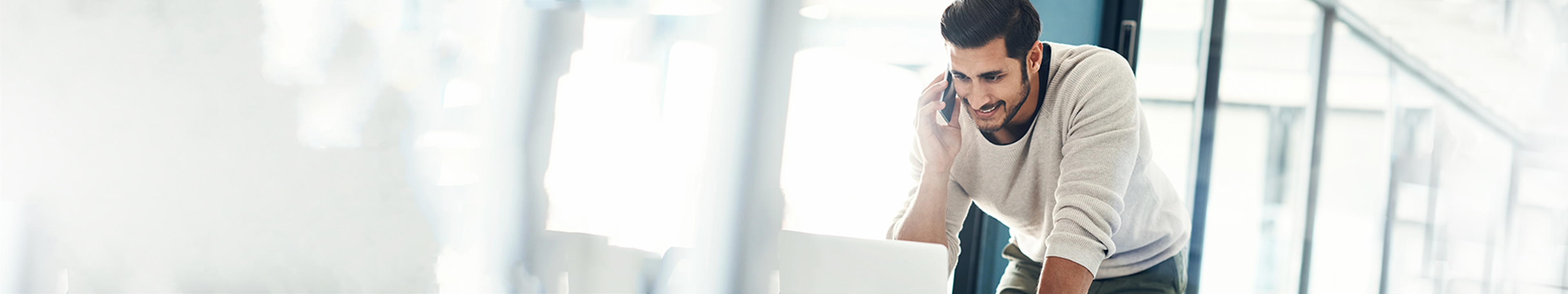 Young man standing in front of laptop