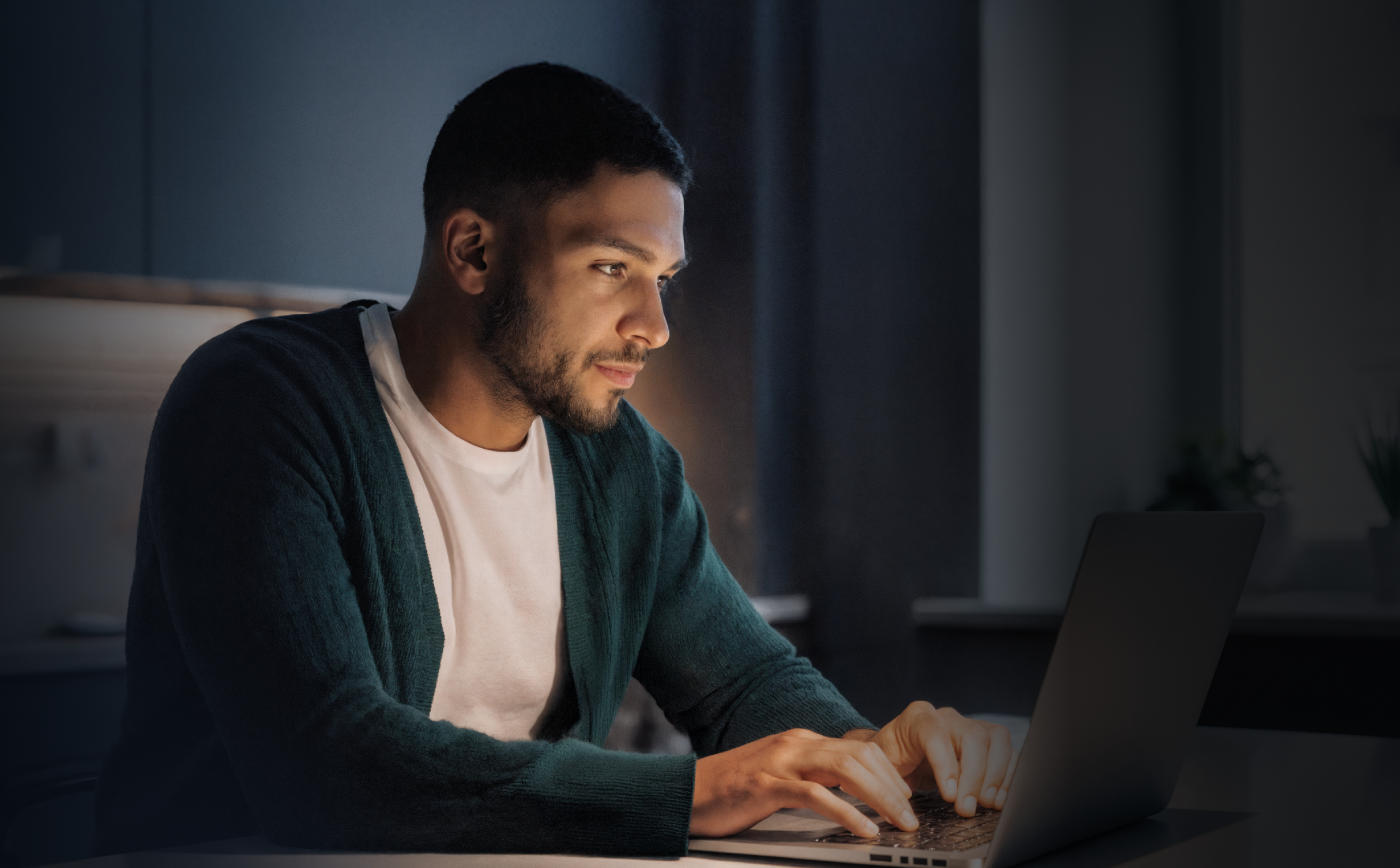Man at computer working in the dark