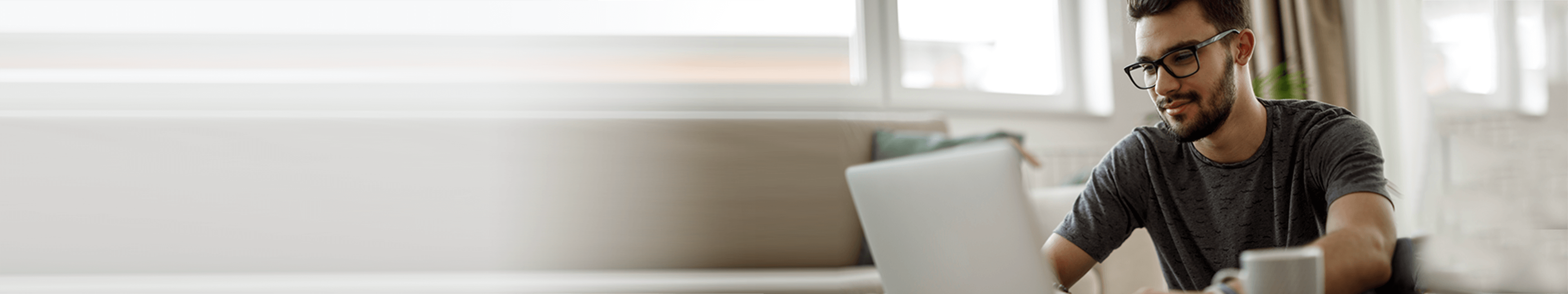 Teenage boy using laptop at home stock