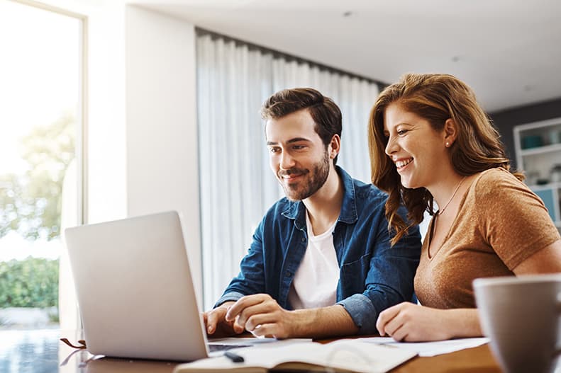 Couple checking their laptop to see different mortgage types