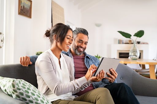 Couple planning their first home with a tablet