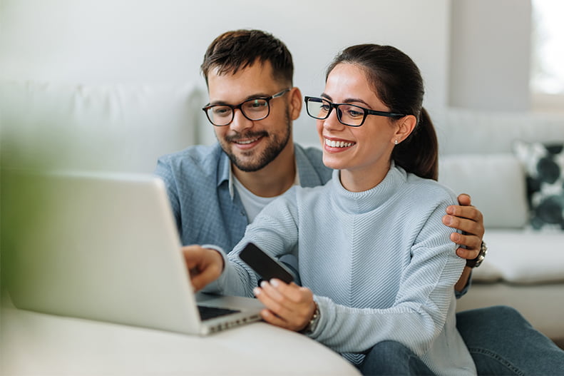 Couple checking their credit score on a laptop