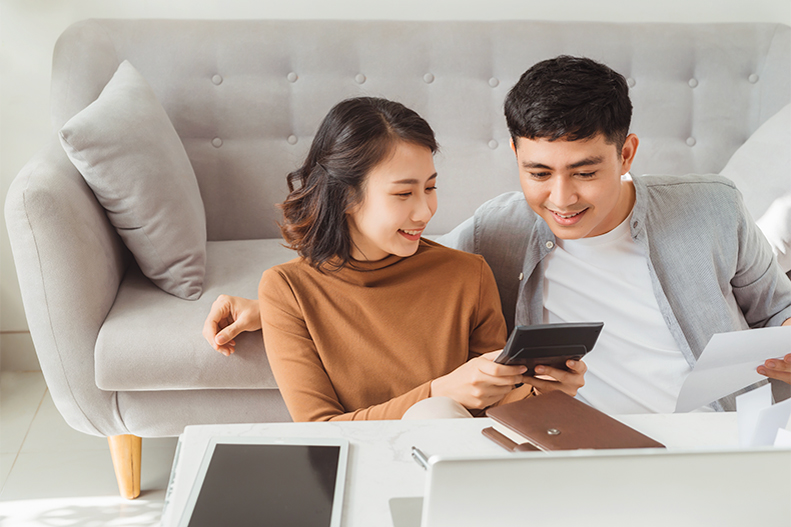 Young couple checking tablet to check their down payment